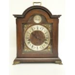 A late 20th century mantel clock in bygone style with silvered Roman chapter ring and cherub mask