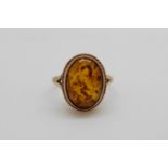 A 9ct gold ring set with pressed amber (size K)