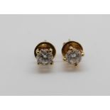 A pair of 18ct gold earrings each set with a round brilliant cut diamond of approximately 0.