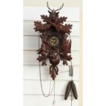 A circa mid 20thC Black Forest carved cuckoo clock in hunting style,