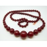 A cherry amber necklace of 79 graduated cylindrcal beads,