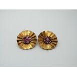 A pair of yellow metal earrings each set with a cluster of rubies to the centre,13.