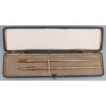 A cased yellow metal dip pen and pencil set, each marked 9ct, weight of both 8.