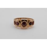 A 15ct gold ring set with five garnets, Chester, 2.