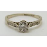An 18ct gold ring set with a diamond measuring approximately 0.
