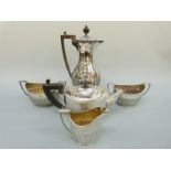 A Victorian and later five piece hallmarked silver tea set with reeded lower body comprising teapot,