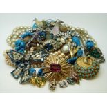 A collection of costume jewellery including an RAF brooch, a Swarovski brooch, bracelet,