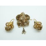 A French filigree gilt floral and foliate brooch set with seed pearls, with matching earrings,