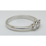 An 18ct white gold ring set with three diamonds, total 0.