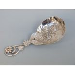 A Victorian hallmarked silver tea caddy spoon with pierced and repoussé floral decoration,