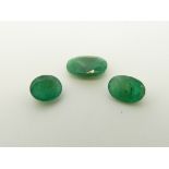 Three oval cut emeralds the largest approximately 1.