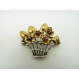 A 9ct bi-coloured gold brooch set with rubies in the form of a basket of flowers, 3.