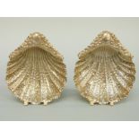A pair of Victorian hallmarked silver shell shaped three footed bonbon dishes,