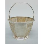 A hallmarked silver pierced bon bon dish or salt in the form of a basket with swing handle with