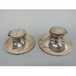 Two early 20thC hallmarked silver capstan inkwells, diameters 11.