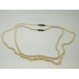 Two pearl necklaces with silver clasps