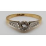 An 18ct gold ring set with a round cut diamond of approximately 0.