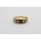 An 18ct gold ring set with a ruby and pearls, 3.