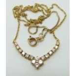 A 10k gold necklace set with diamonds in a V shape, 4.