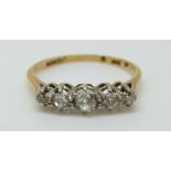 An 18ct gold ring set with five old cut diamonds in a platinum setting,