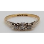 An 18ct gold ring set with three diamonds in a platinum setting, 2.