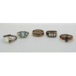Two silver rings set with blue topaz, a silver ring set with a sapphire,
