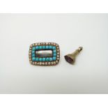 A Victorian mourning brooch set with a row of turquoise and pearls with a small fob