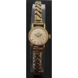 Omega gold plated ladies wristwatch with gold hands and baton markers and white face,