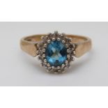 A 9ct gold ring set with blue topaz and diamonds (size J)