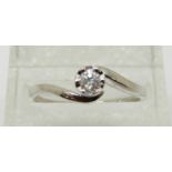 A 9ct white gold ring set with a diamond solitaire of approximately 0.