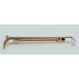 A 9ct and 18ct gold tie pin in the form of a riding crop 6cm, 2.