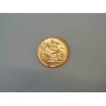 A 1909 gold sovereign,