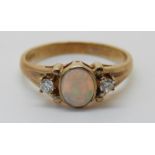 A 9ct gold ring set with an opal and diamonds (size N)