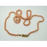 A beaded coral necklace with 9ct gold clasp