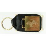 A 9ct gold Ferrari key ring with leather fob, B'ham 1998, approximately 12g,