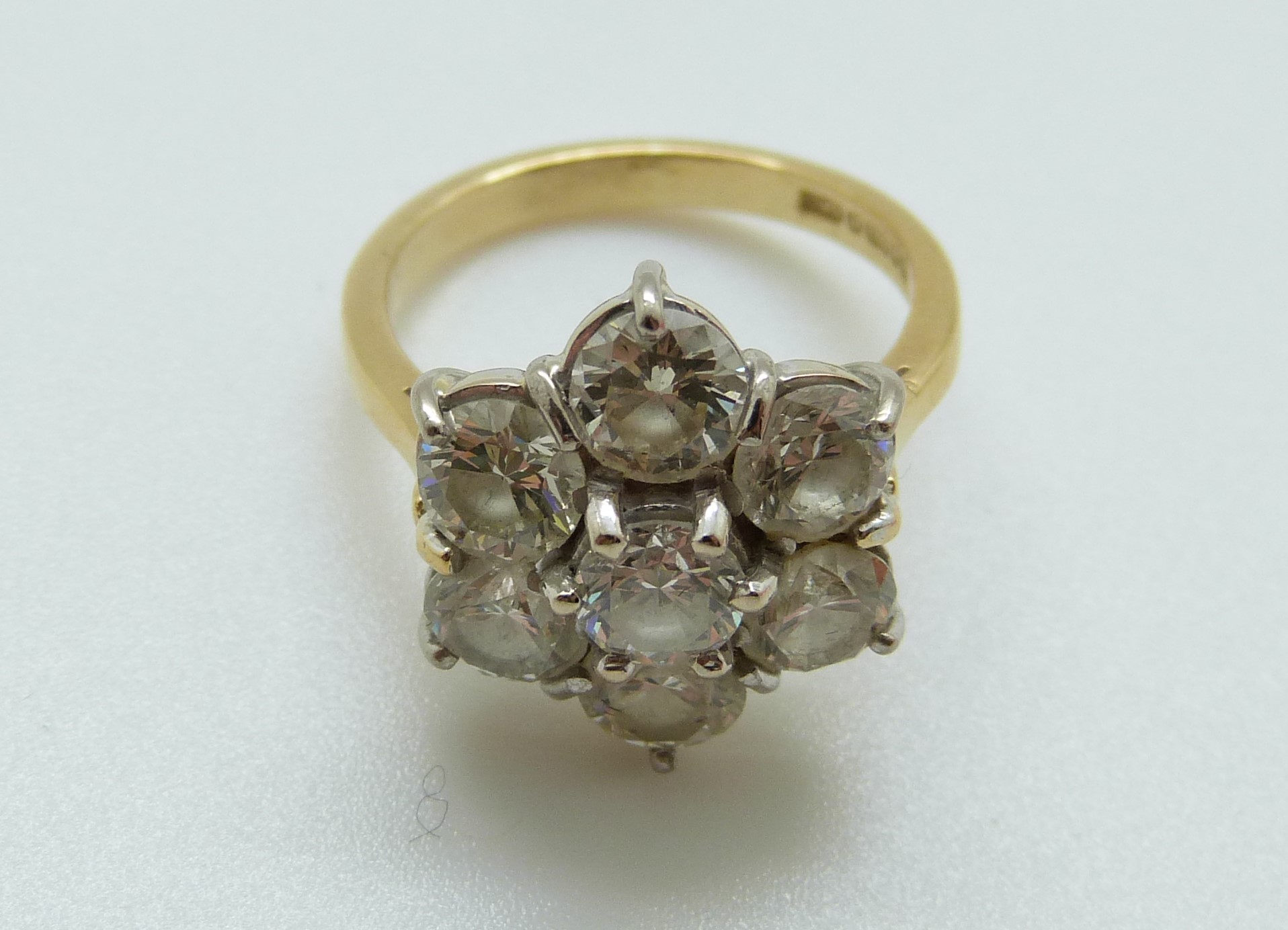 An 18ct gold ring set with seven round brilliant cut diamonds in a cluster, - Image 4 of 6