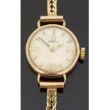 Tissot 9ct gold ladies wristwatch with baton markers and two tone hands, on 9ct gold bracelet,