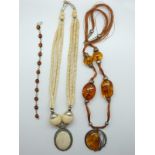 A pressed amber bracelet and necklace and a bone necklace