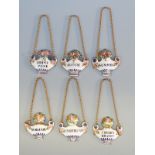 A set of six 19thC Dreyfous enamel bottle tickets comprising Burgundy, Rhine wine, Cherry Brandy,