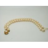 A two-strand cultured pearl bracelet with 9ct gold clasp