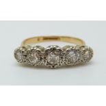 An 18ct gold ring set with five diamonds in an illusion setting, the centre stone approximately 0.