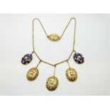 A Victorian yellow metal necklace with five oval drop sections,