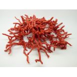 A large coral necklace made up of natural strands with silver clasp