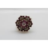 A 9ct gold ring set with diamonds and rubies in a large cluster, 3.
