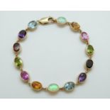 A 9ct gold bracelet set with oval opals, citrines, pink topaz, garnets,