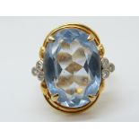 An 18ct gold ring set with a large oval topaz and diamonds (size M)