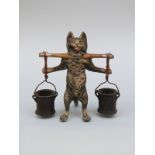 An Austrian cold painted bronze figure of a cat with yoke and buckets, height 8.