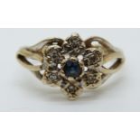 A 9ct gold ring set with a sapphire surrounded by diamonds in a cluster (size K)