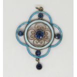 A silver pendant with blue enamel decoration set with blue stones,