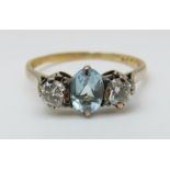 An 18ct gold ring set with an oval cut aquamarine and two diamonds, each approximately 0.